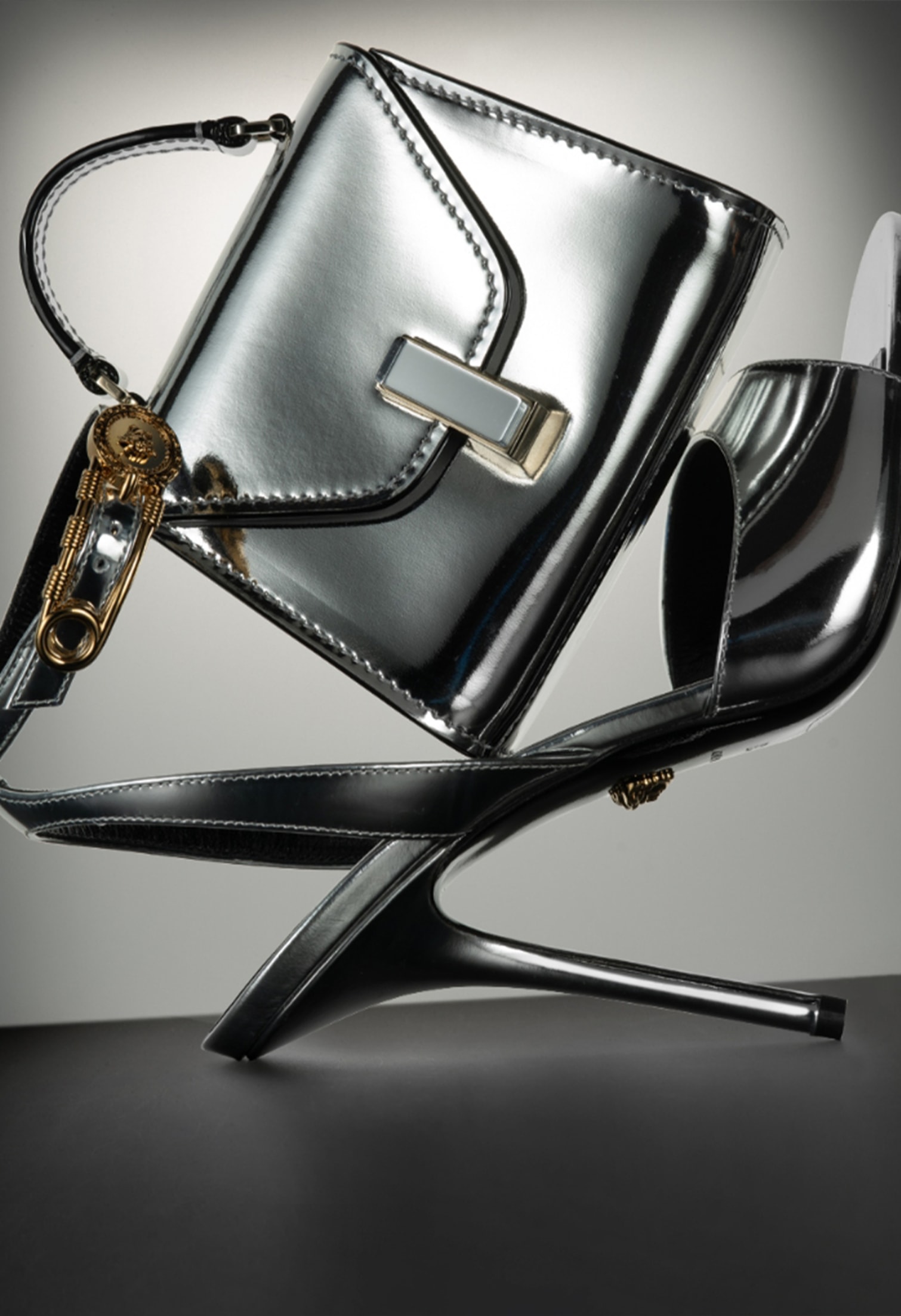 Bring THE DRAMA Spring’s Best Accessories - VERSACE 110mm Mirroring Leather Sandals. VALEXTRA Iside Mirror Belt Bag.