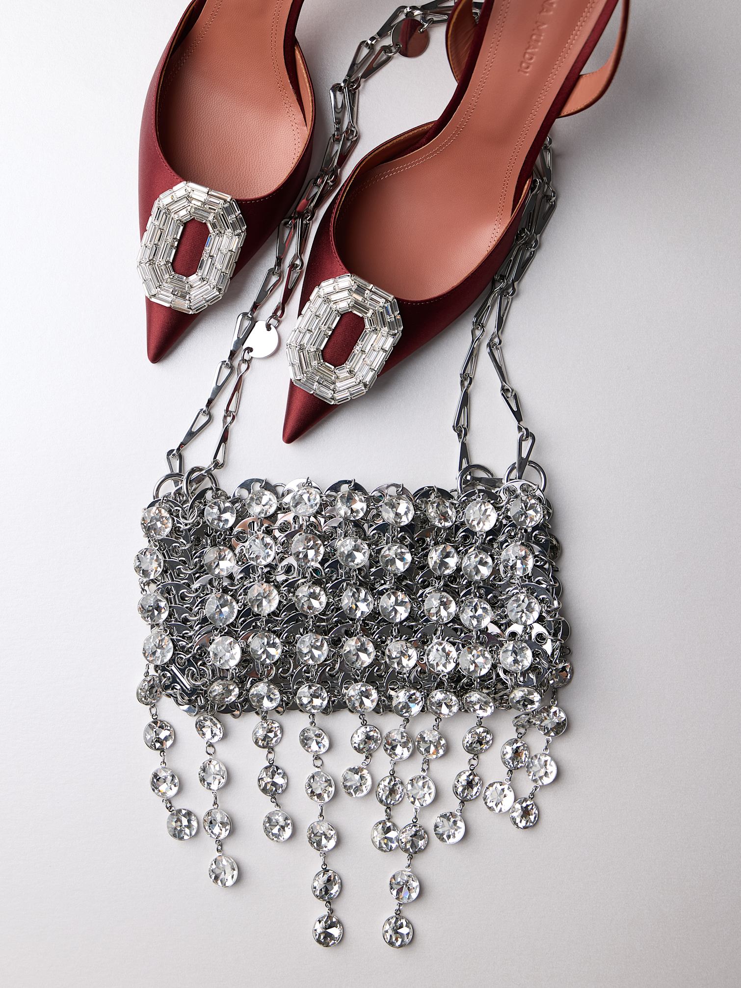 Crystal and metal chain mini shoulder bag with burgundy pointed toe slingbacks and crystal detail