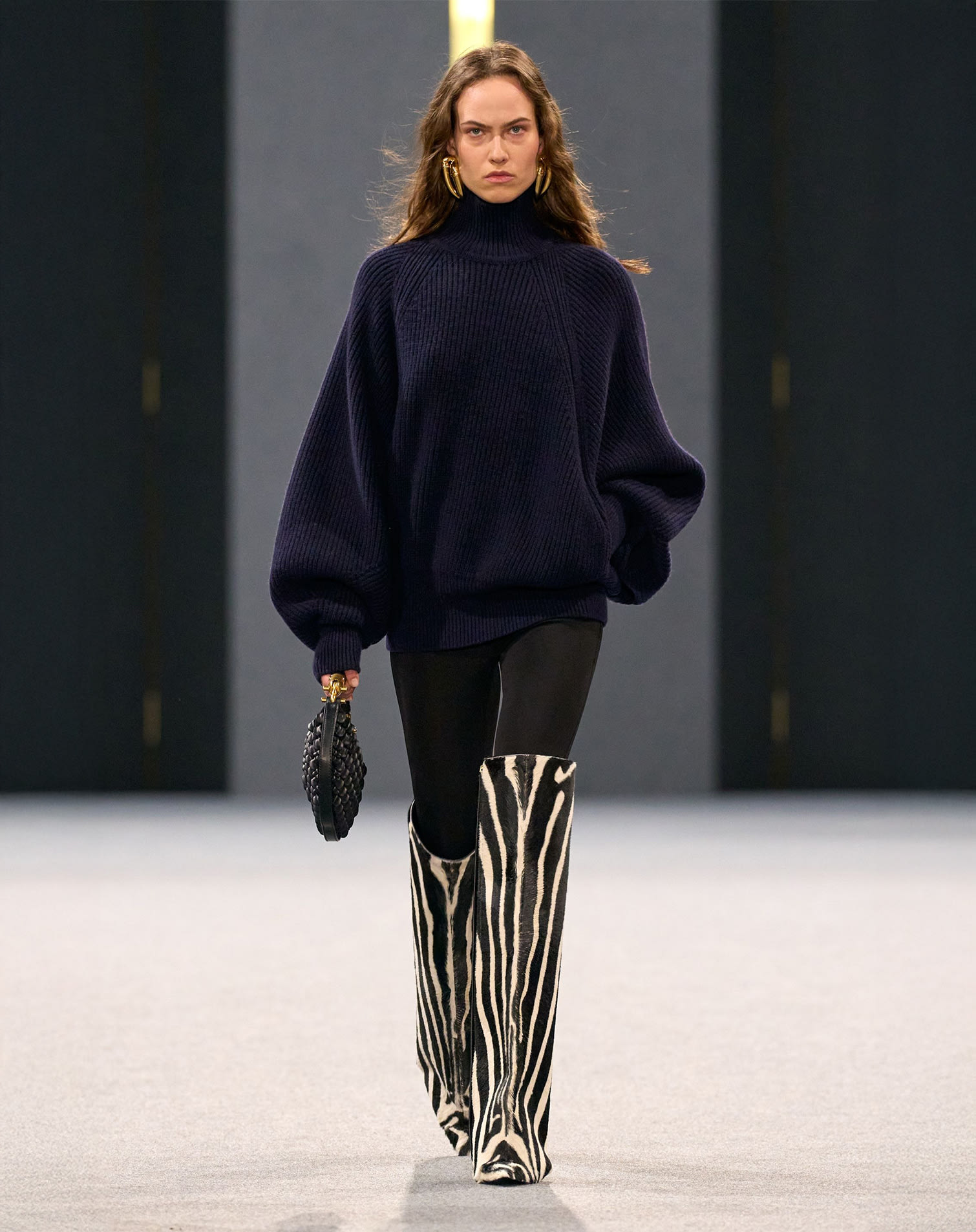 Runway model with zebra print knee-high boots