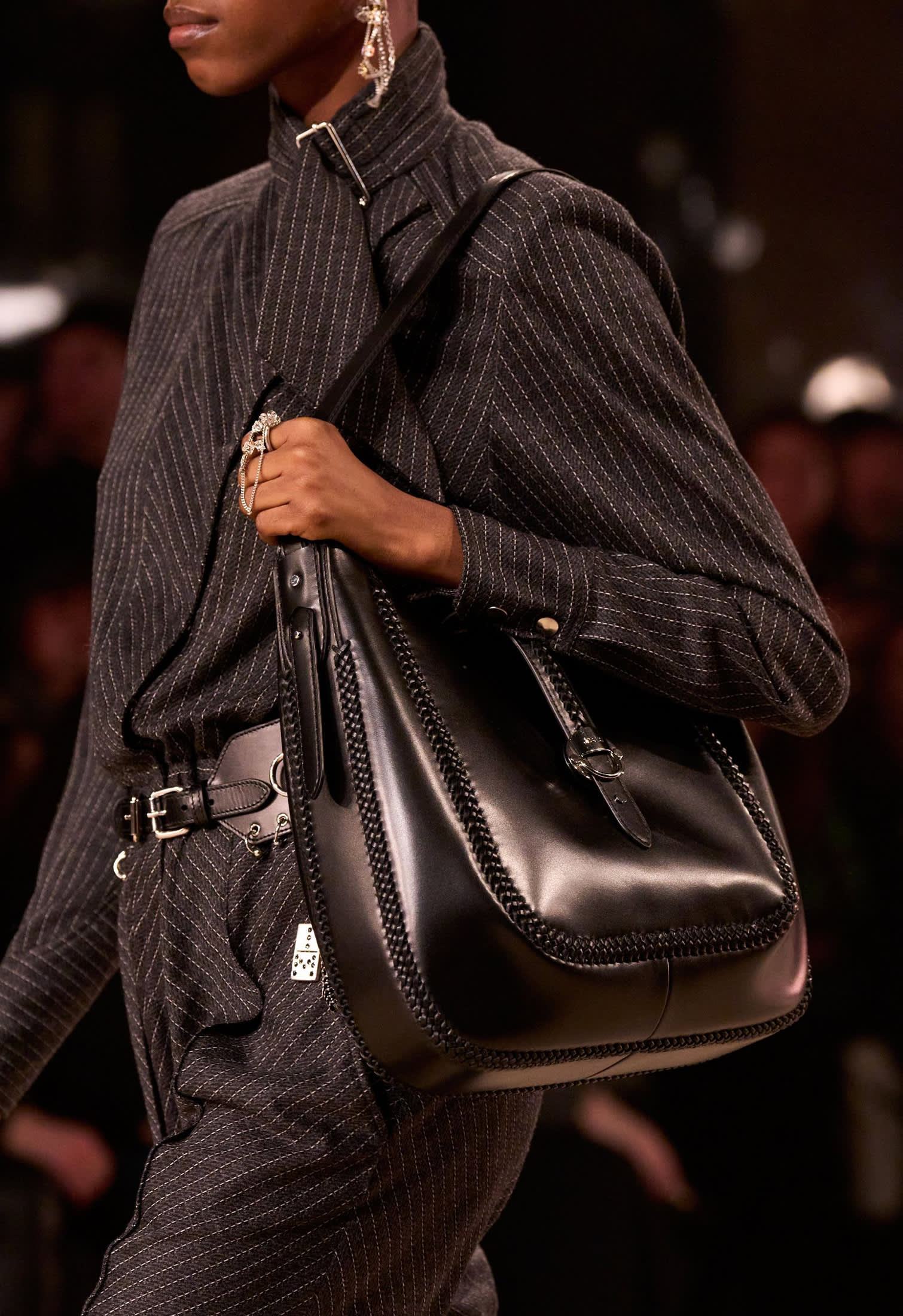 Runway look with belted shoulder bag with decorative strap