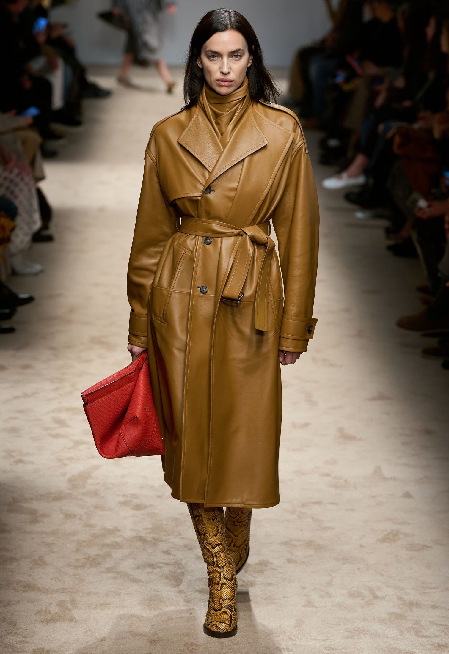 Runway model with trench and animal print boots