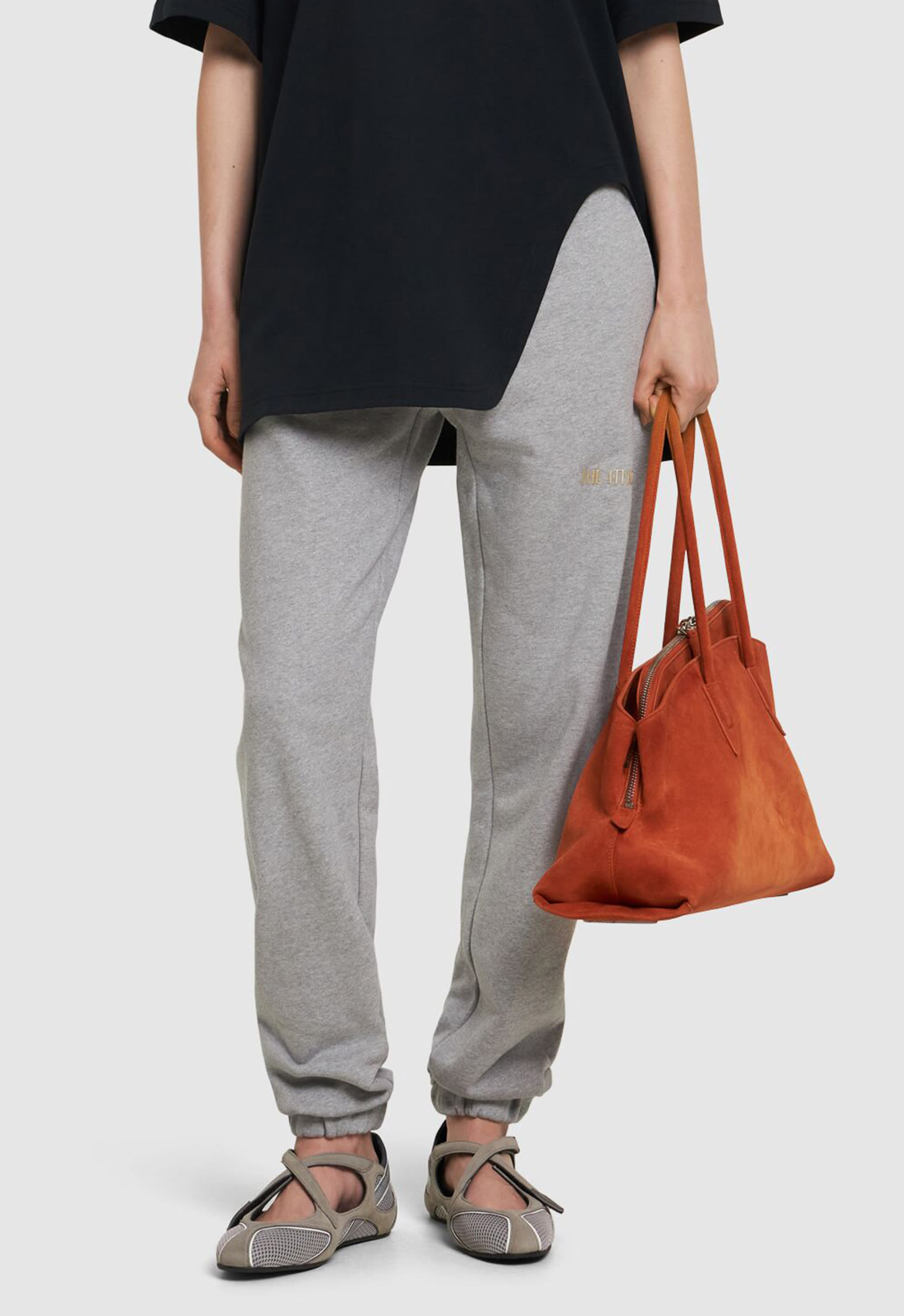 Model with comfort chic flat shoes and red bag