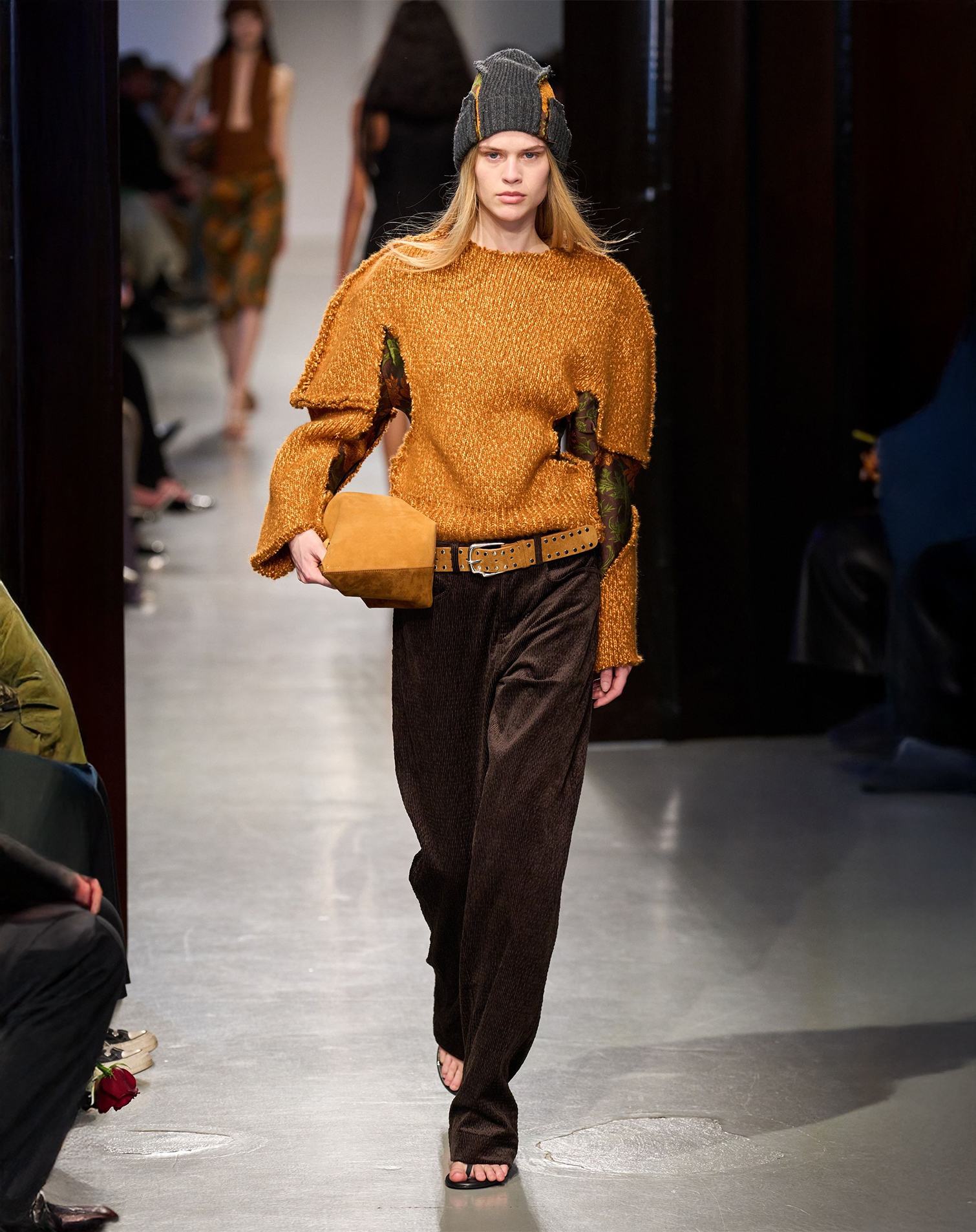 Runway look with mustard yellow sweater and brown corduroy pants with matching bag