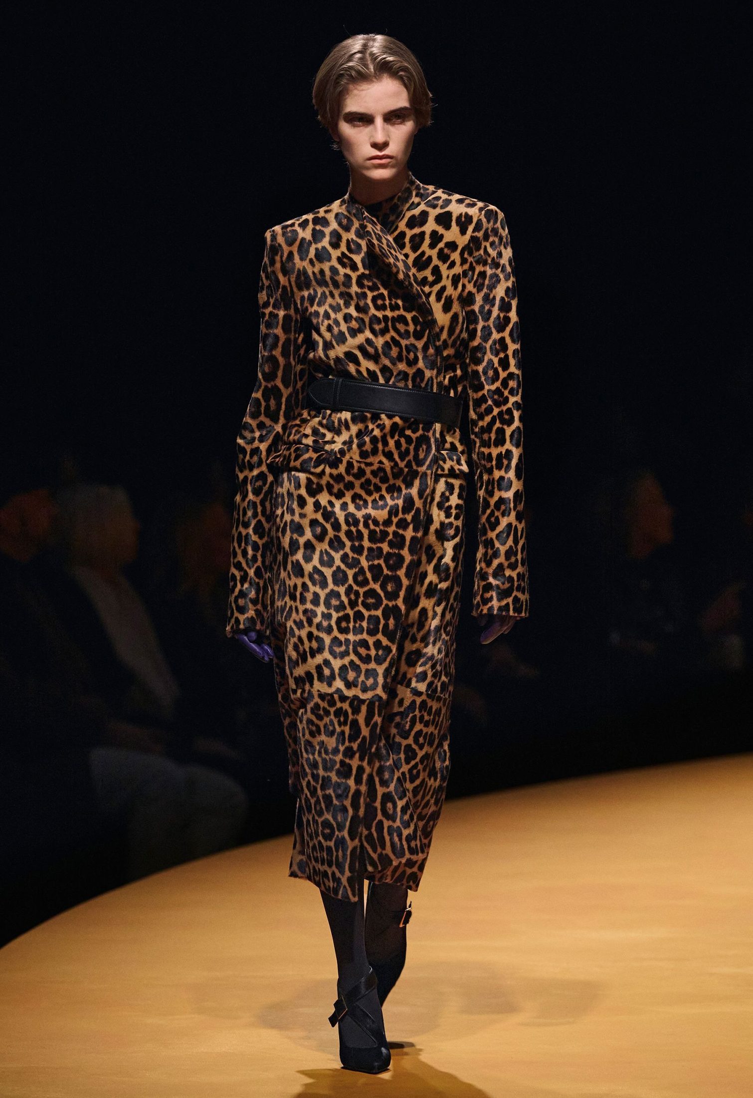Model in runway with leopard print fur coat by Khaite