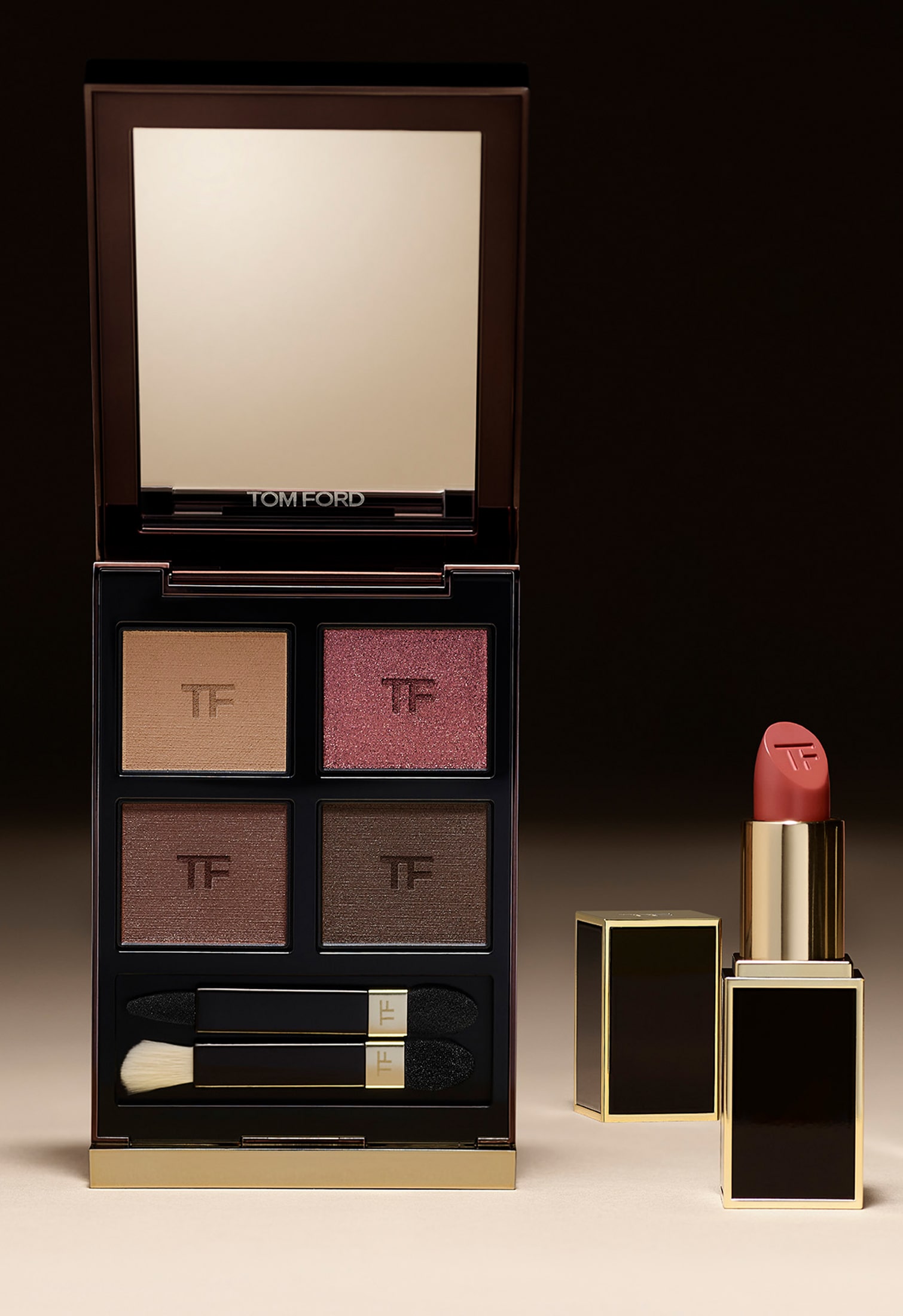 Tom Ford eyeshadow palette in neutral and plum tones with a nude lipstick placed beside it on a dark background.