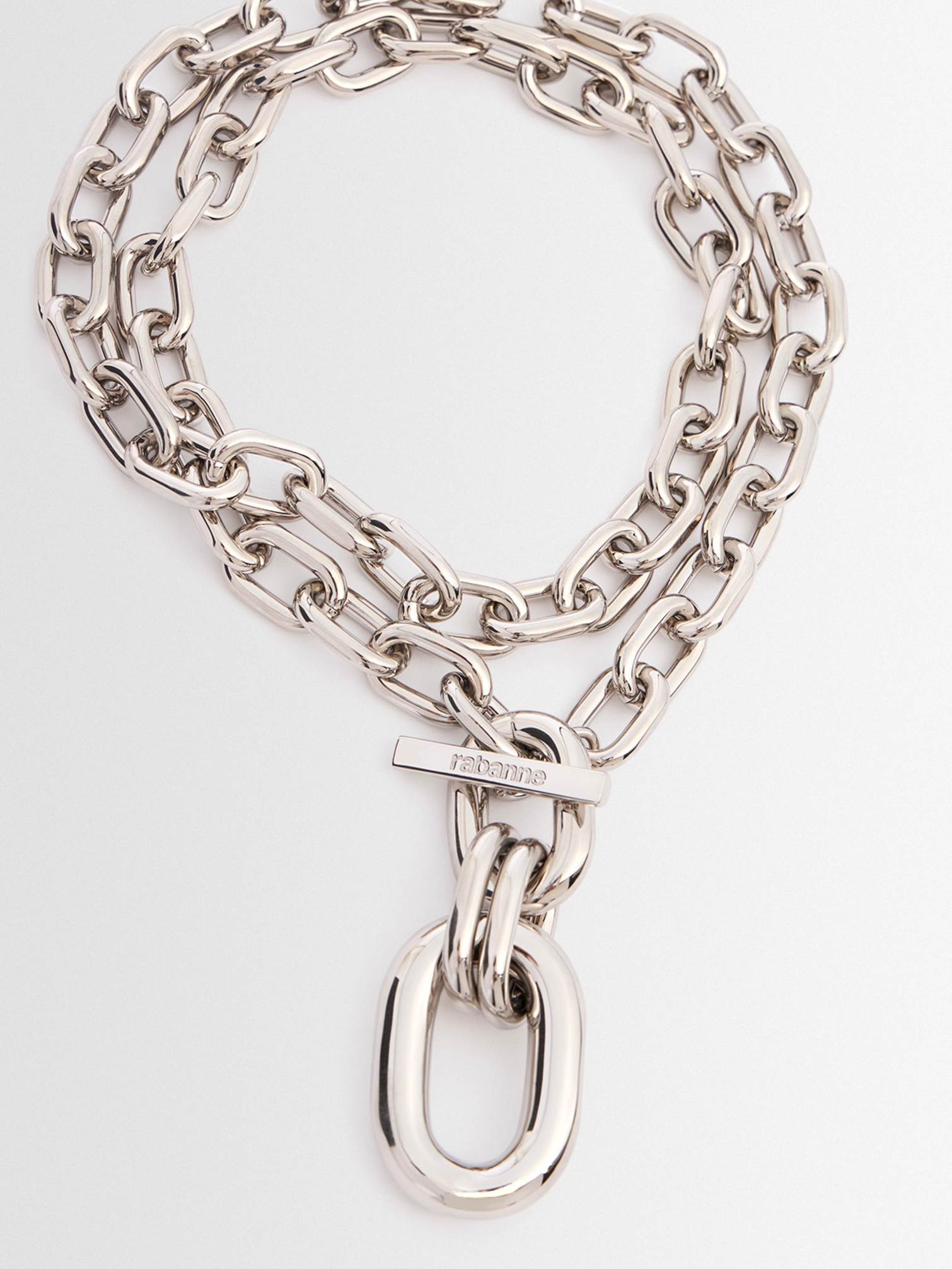Close-up of a chunky silver chain necklace by Rabanne with oversized links, adding bold metallic flair to Christmas outfits.