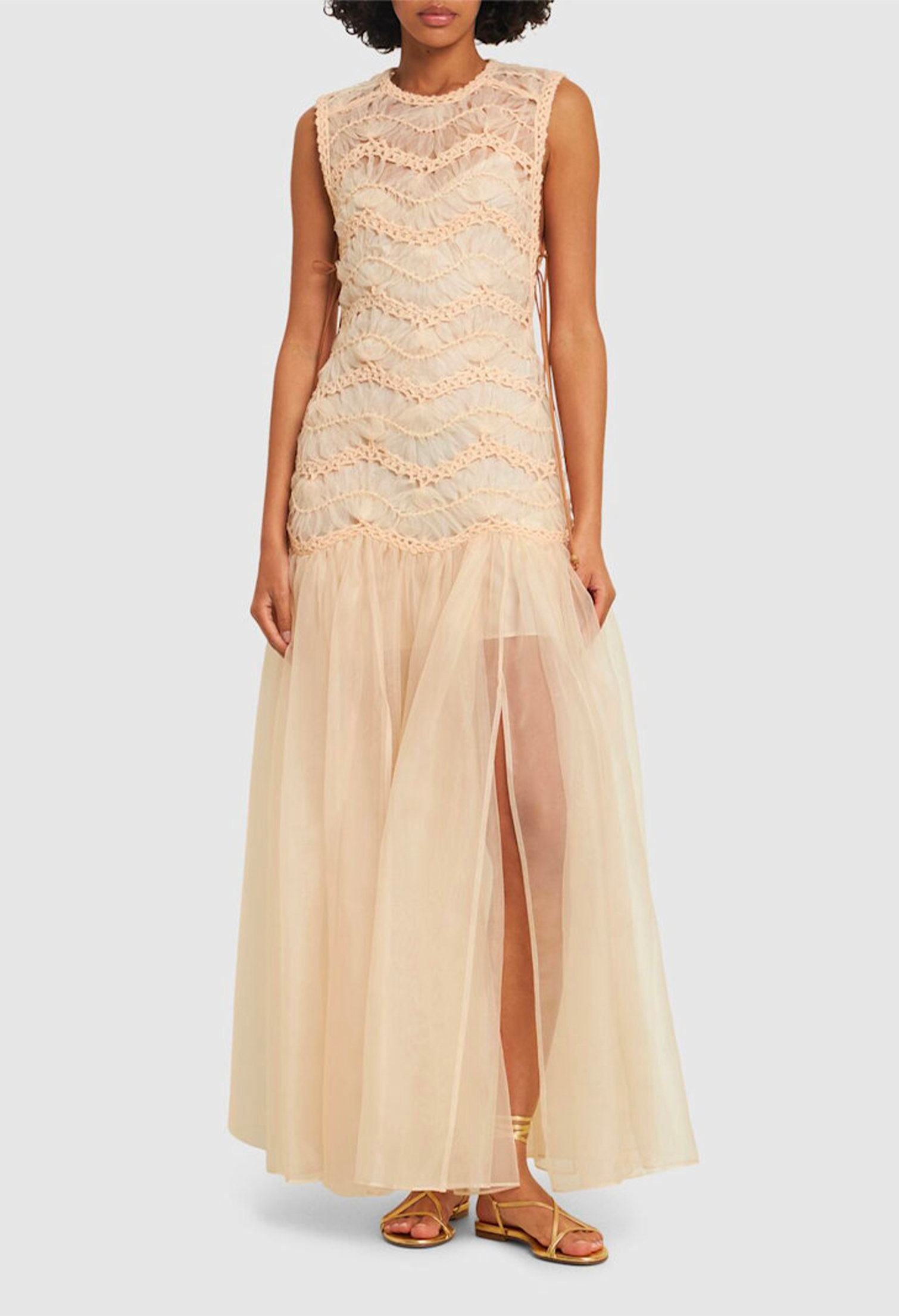 Model with sheer beige long dress with embroidery details